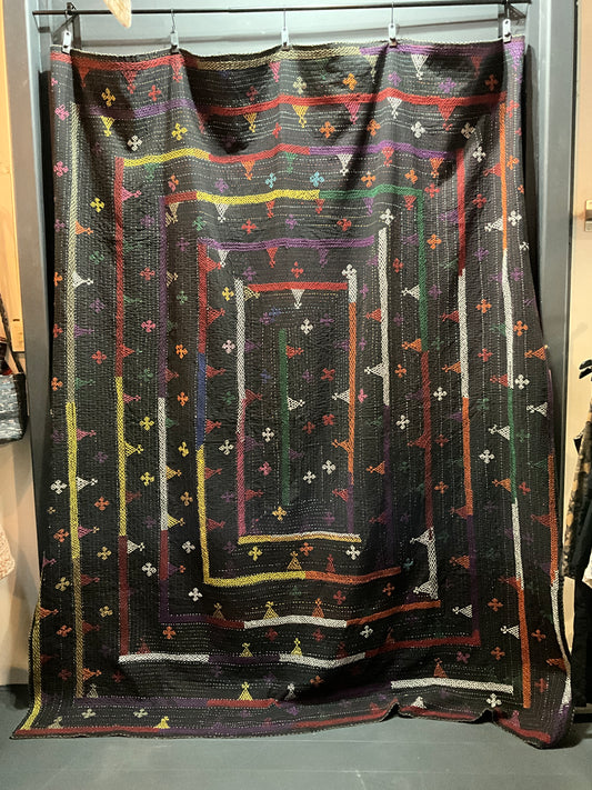 Hand stitched quilt in black with multi coloured embroidery